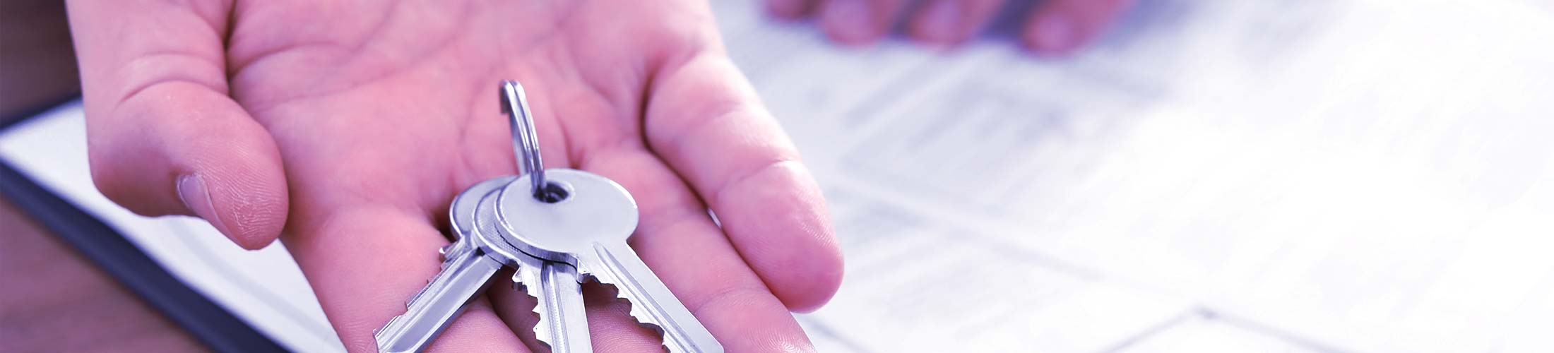 image of attorney handing over keys for commercial real estate