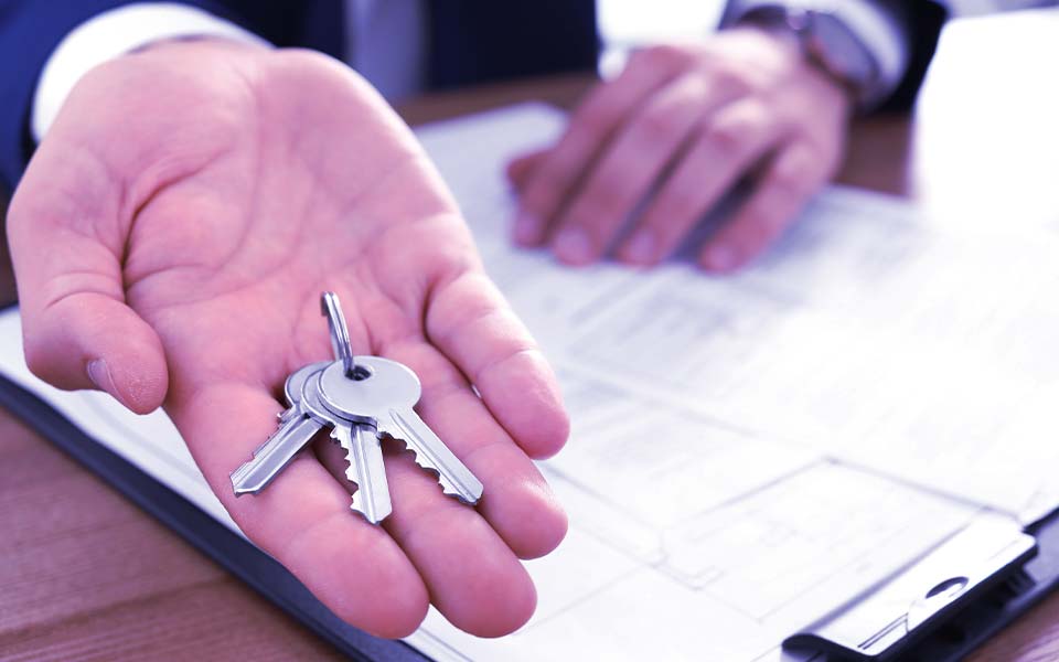 image of attorney handing over keys to commercial property.